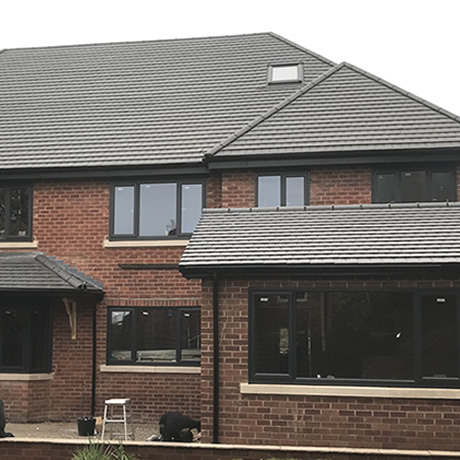 A Smart Aluminium bi-folding door and windows finished in anthracite grey finish installed in St. Bearnards Road, Solihull